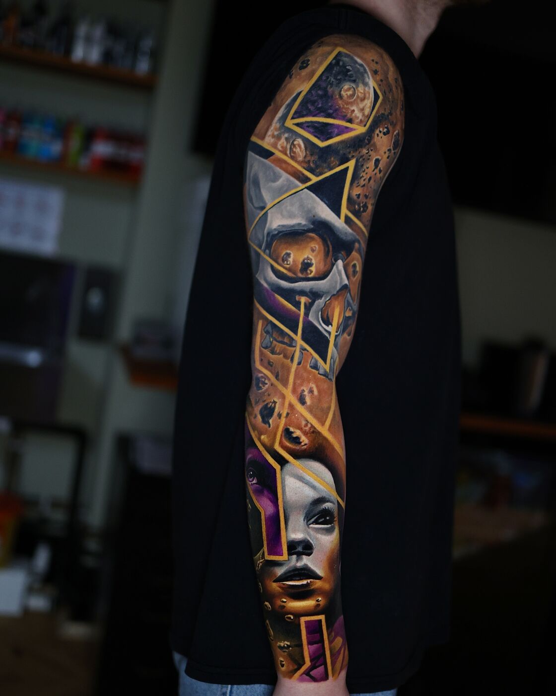 Full sleeve — abstract geometric portrait tattoo by Volkan Demirci
